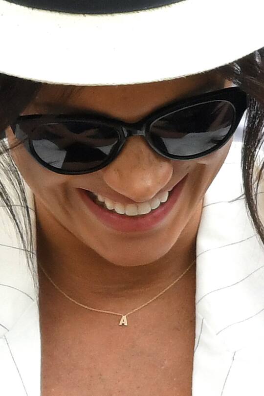 LONDON, ENGLAND - JULY 04: Meghan, Duchess of Sussex, necklace detail, attends day four of the Wimbledon Tennis Championships at All England Lawn Tennis and Croquet Club on July 04, 2019 in London, England. (Photo by Karwai Tang/Getty Images)