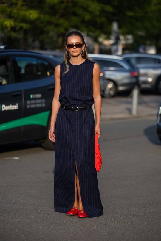 COPENHAGEN, DENMARK - AUGUST 07: A guest wears naavy striped skirt, skirt, red bag outside Baum & Pferdgarten during day three of the Copenhagen Fashion Week (CPHFW) SS25 on August 07, 2024 in Copenhagen, Denmark. (Photo by Christian Vierig/Getty Images)