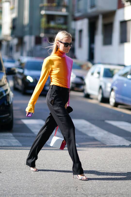 MILAN, ITALY - SEPTEMBER 20: Thora Valdimars wears sunglasses, a yellow and pink turtleneck top, black flared pants, outside the Marni show during Milan Fashion Week Spring/Summer 2020 on September 20, 2019 in Milan, Italy. (Photo by Edward Berthelot/Getty Images)