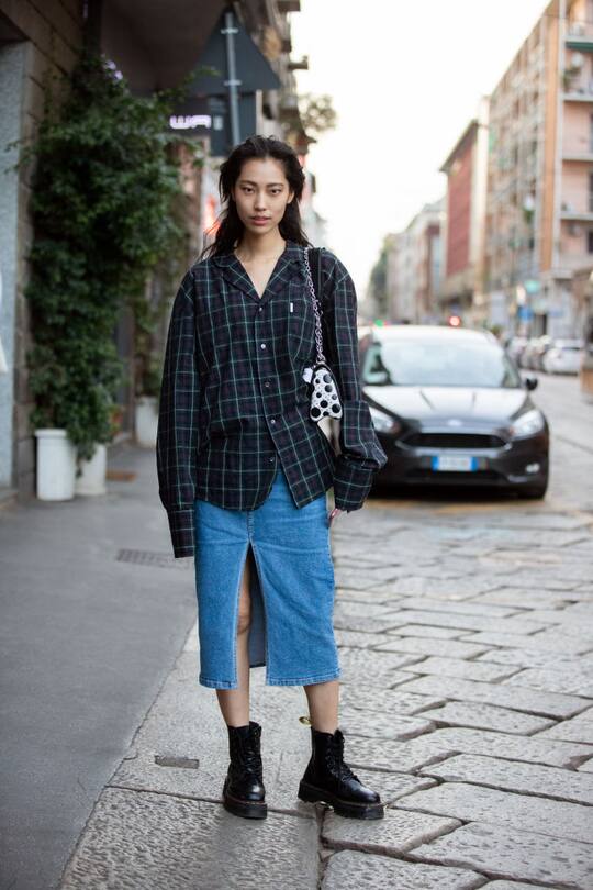 MILAN, ITALY - SEPTEMBER 21: Model Heejung Park wears a blue plaid shirt, denim skirt, black boots after the Agnona show during Milan Fashion Week Spring/Summer 2020 on September 21, 2019 in Milan, Italy. (Photo by Melodie Jeng/Getty Images)