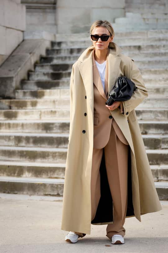 PARIS, FRANCE - MARCH 03: A guest wearing trench, beige suit and black Bottega Veneta bag outside the Chanel show during Paris Fashion Week Womenswear Fall/Winter 2020/2021 Day Nine on March 03, 2020 in Paris, France. (Photo by Hanna Lassen/Getty Images)