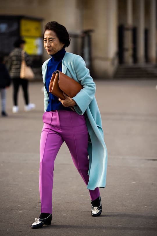 PARIS, FRANCE - FEBRUARY 29: A guest, wearing a blue turtleneck sweater, pink pants, light blue coat and tan bag, is seen outside Haider Ackermann, during Paris Fashion Week - Womenswear Fall/Winter 2020/2021 : Day Six on February 29, 2020 in Paris, France. (Photo by Claudio Lavenia/Getty Images)