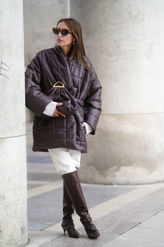 PARIS, FRANCE - MARCH 03: Chloe Harrouche wears sunglasses, a brown quilted oversized coat, a puff bag, white pants, brown leather pointy boots, outside Gauchere, during Paris Fashion Week - Womenswear Fall/Winter 2020/2021 on March 03, 2020 in Paris, France. (Photo by Edward Berthelot/Getty Images)