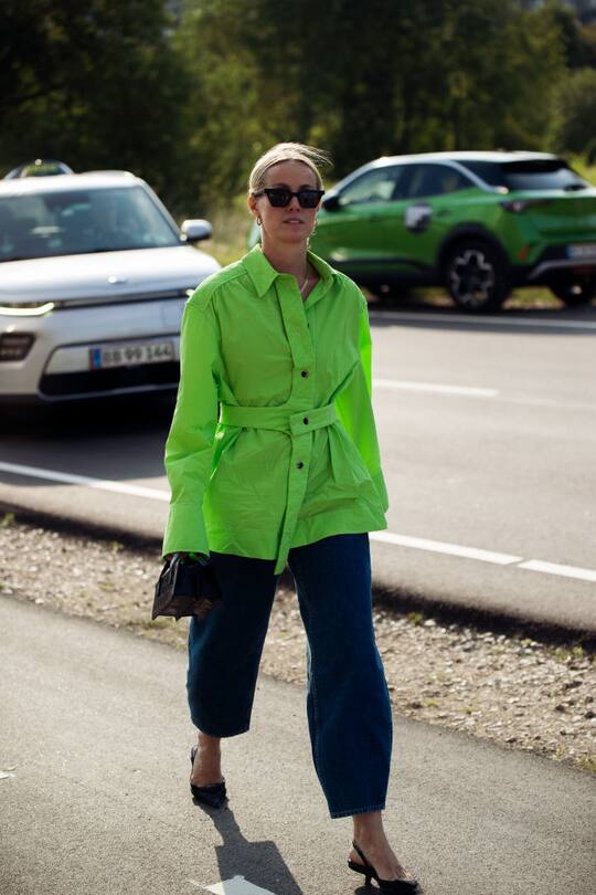 COPENHAGEN, DENMARK - AUGUST 12: Cicilie Thorsmark wearing blue pants and green shirt outside Ganni during Copenhagen fashion week SS22 on August 12, 2021 in Copenhagen, Denmark. (Photo by Raimonda Kulikauskiene/Getty Images)