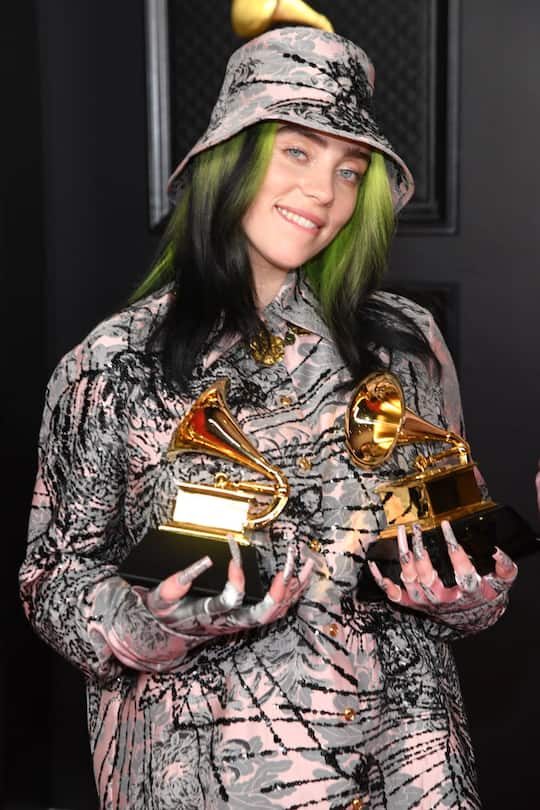 LOS ANGELES, CALIFORNIA - MARCH 14: Billie Eilish, winner of the Record of the Year award for 'Everything I Wanted' and the Best Song Written for Visual Media award for âNo Time to Die,â poses in the media room during the 63rd Annual GRAMMY Awards at Los Angeles Convention Center on March 14, 2021 in Los Angeles, California. (Photo by Kevin Mazur/Getty Images for The Recording Academy )