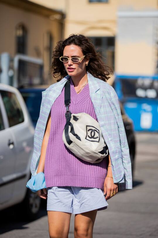 COPENHAGEN, DENMARK - AUGUST 11: A guest is seen wearing purple Keiko vest 11250, shirt, chanel bag, shorts outside Samsøe & Samsøe during Copenhagen Fashion Week Spring/Summer 2021 on August 11, 2020 in Copenhagen, Denmark. (Photo by Christian Vierig/Getty Images)