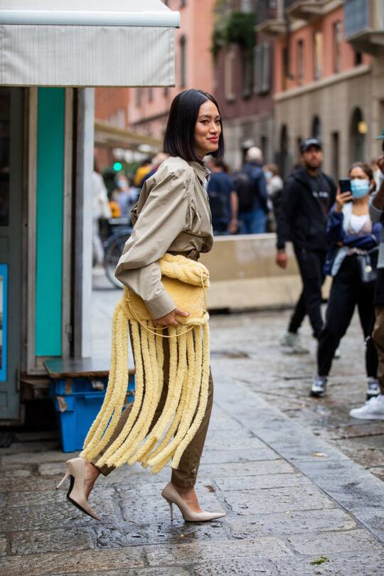 MILAN, ITALY - SEPTEMBER 24: Tiffany Hsu is seen wearing khaki pants, yellow bag with fringes outside Max Mara during the Milan Women's Fashion Week on September 24, 2020 in Milan, Italy. (Photo by Christian Vierig/Getty Images)