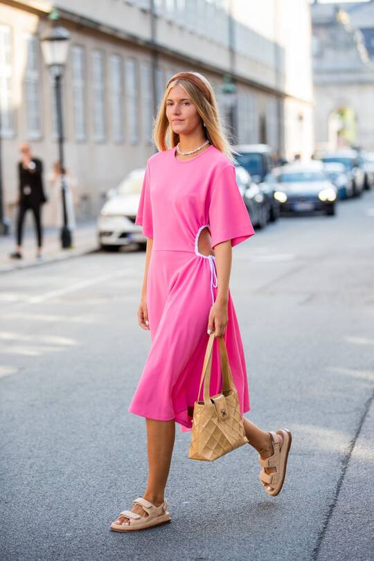 COPENHAGEN, DENMARK - AUGUST 07: A guest is seen wearing pink ripped dress, beige Chanel bag, sandals outside Helmstedt during Copenhagen Fashion Week Spring/Summer 2020 on August 07, 2019 in Copenhagen, Denmark. (Photo by Christian Vierig/Getty Images)