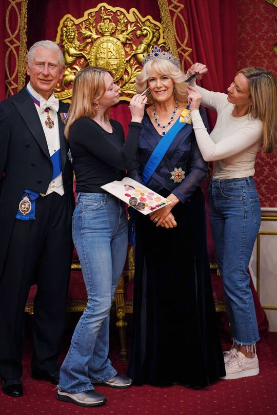 Studio artists Sophie Greenaway (left) and Claire Parkes add the finishing touches to a new Queen Consort wax figure at Madame Tussauds in London, ahead of the coronation of King Charles III on May 6. Picture date: Wednesday April 26, 2023. (Photo by Yui Mok/PA Images via Getty Images)