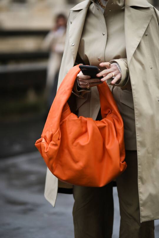 PARIS, FRANCE - MARCH 01: Fashion Week guest is seen wearing a orange Bottega Veneta bag outside Valentino show during Paris Fashion week Womenswear Fall/Winter 2020/2021 Day Seven on March 01, 2020 in Paris, France. (Photo by Jeremy Moeller/Getty Images)