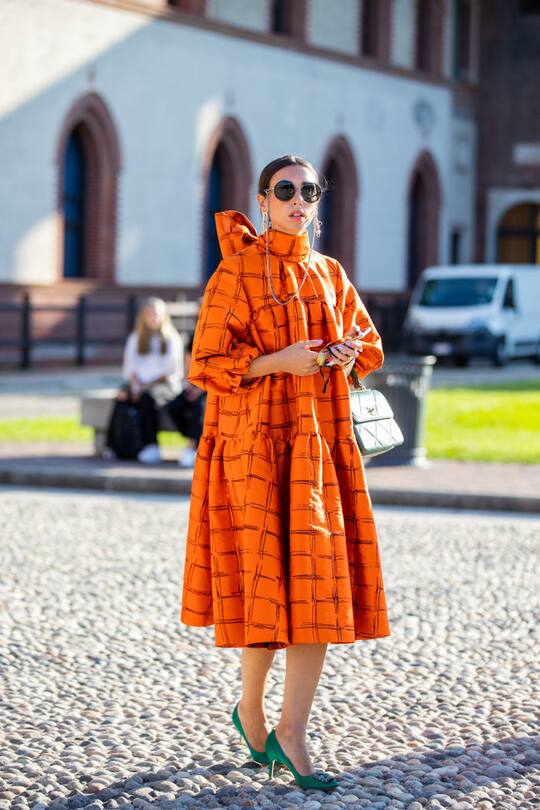 MILAN, ITALY - SEPTEMBER 23: A guest is seen wearing orange dress outside Alberta Ferretti during the Milan Women's Fashion Week on September 23, 2020 in Milan, Italy. (Photo by Christian Vierig/Getty Images)