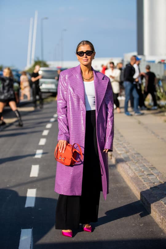 COPENHAGEN, DENMARK - AUGUST 12: Darja Barannik seen wearing purple coat, black pants, red bag outside Ganni on August 12, 2021 in Copenhagen, Denmark. (Photo by Christian Vierig/Getty Images)