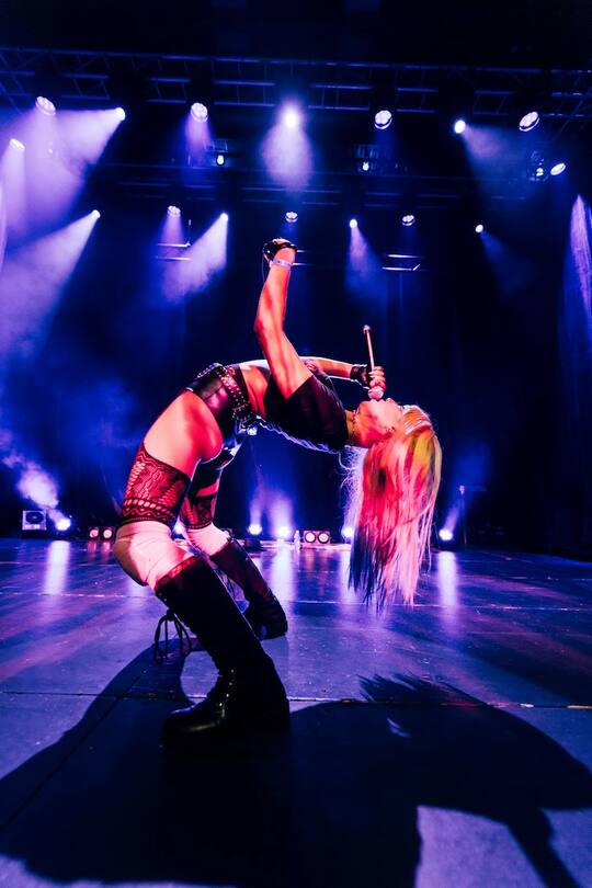 a singer bending backwards on stage