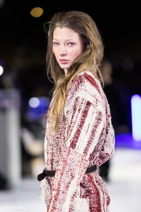 a model from the side wearing her hair open and a woolen overall