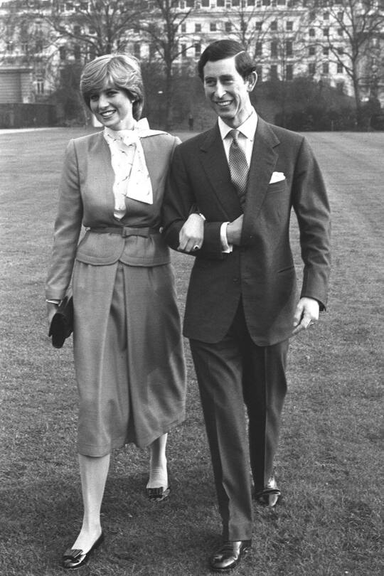 Prince Charles and Lady Diana Spencer, 19, walking arm in arm at Buckingham Palace after announcing their engagement. (Photo by PA Images via Getty Images)