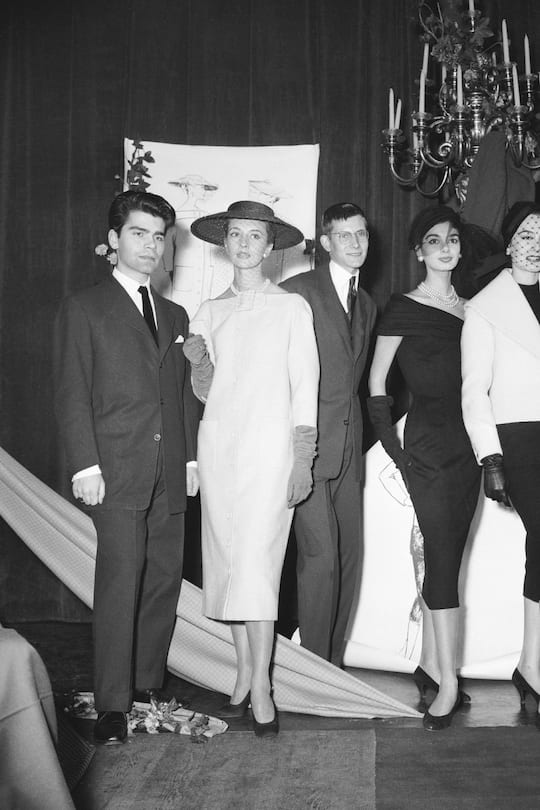 FRANCE - DECEMBER 11: Karl LAGERFELD (21) and Yves SAINT LAURENT (18), unknown at that time, won a first prizeat a fashion design show organized by the International Wool Secretary in a Parisian bar. Karl LAGERFELD was awarded in the coat category and Yves SAINT LAURENT in the dress category. Colette BRACCHI received the first prize in the suit category. The group is posing among the models that presented their collections. (Photo by Keystone-France/Gamma-Keystone via Getty Images)