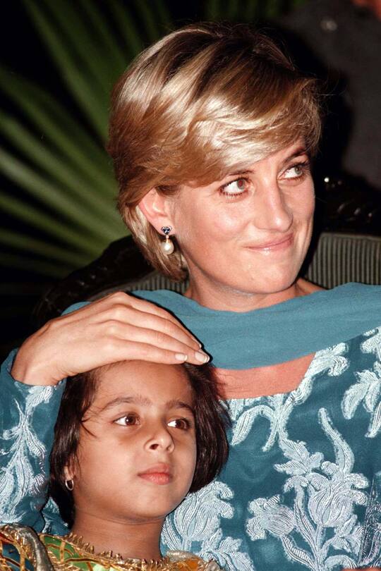 Diana Princess of Wales sits with a young girl at fund raising event at the Cancer Memorial Hospital in Lahore, Pakistan which was founded by Imran Kahn. Picture by Stefan Rousseau (Photo by Stefan Rousseau - PA Images/PA Images via Getty Images)