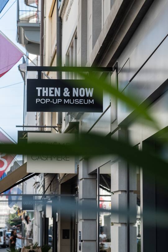 a store sign on a shopping street in switzerland