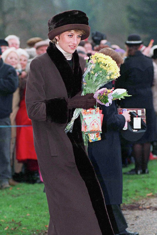SANDRINGHAM, UNITED KINGDOM - DECEMBER 25: Princess Diana Holding Flowers And Christmas Presents From Members Of The Crowd That Have Gathered After Christmas Day Service At Sandringham Church (Photo by Tim Graham Photo Library via Getty Images)