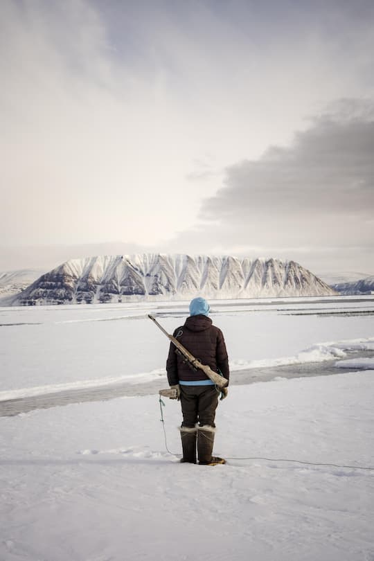 <p>Auf der Lauer: Ein Jäger wartet auf Robben, die zum Luftholen zwischen den Eisplatten auftauchen.</p>