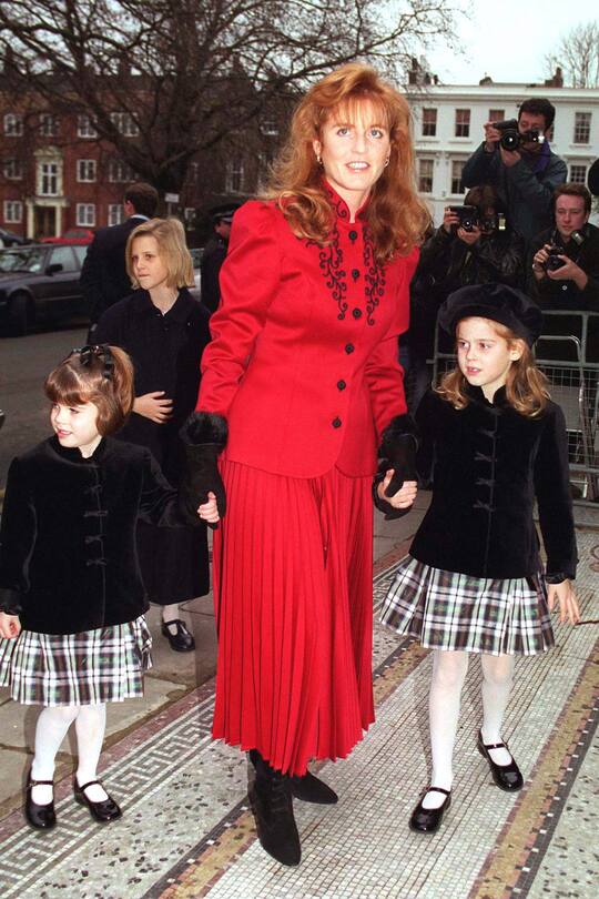 LONDON, UNITED KINGDOM - DECEMBER 18: Duchess Of York With Her Daughters Princess Beatrice And Princess Eugenie Attending Christmas Pantomime 'cinderella' In Aid Of Children In Crisis Of Which The Duchess Is Patron. (Photo by Tim Graham Photo Library via Getty Images)