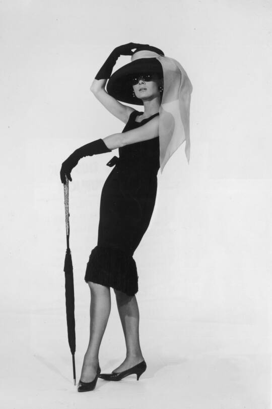 1961: Belgian-born actress Audrey Hepburn (1929 - 1993) in a black cocktail dress designed by French couturier Hubert de Givenchy in a promotional portrait for director Blake Edwards's film, 'Breakfast at Tiffany's'. (Photo by Hulton Archive/Getty Images) STYLE 01/25