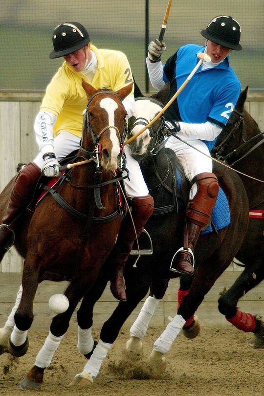 Prince William and Prince Harry barging against each other during a charity polo match at Longdole Polo Club in Birdlip. Prince Harry was on the winning team Lovelocks while Prince William played for the Hayley team. | Location: Birdlip, Gloucestershire, UK. (Photo by © Pool Photograph/Corbis/Corbis via Getty Images)