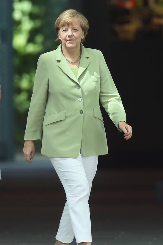 BERLIN, GERMANY - JUNE 18: German Chancellor Angela Merkel prepares to greet Tunisian Prime Minister Mehdi Jomaa at the Chancellery on June 18, 2014 in Berlin, Germany. Jomaa is on his first official state visit to Germany. (Photo by Sean Gallup/Getty Images)