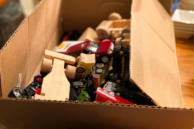 box brimming with used toys