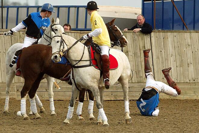 Prince William falls from his horse while playing against his brother Prince Harry (in yellow) in a charity polo match at Longdole Polo Club in Birdlip. Prince Harry was on the winning team William was playing for the Hayley team alongside Norman Bellone and Austin Clarke. Harry was playing for Lovelocks alongside father-and-son team Robert and Matthew Cudmore. | Location: Birdlip, Gloucestershire, UK. (Photo by © Pool Photograph/Corbis/Corbis via Getty Images)