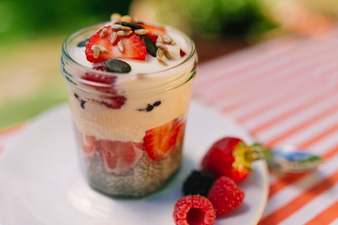 Fresh prepared glass of overnight oats with greek yogurt and strawberrys, raspberry and blueberry.