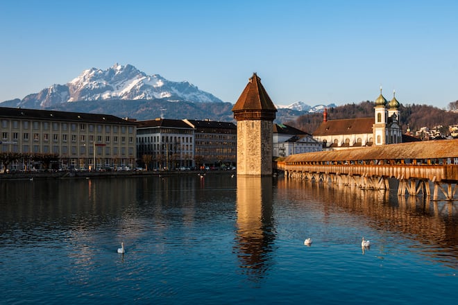 Lucerne is a city in north-central Switzerland, in the German-speaking portion of that country. Lucerne is the capital of the Canton of Lucerne and the capital of the district of the same name. Due to its location on the shore of Lake Lucerne , within sight of Mount Pilatus and Rigi in the Swiss Alps, Lucerne has long been a destination for tourists. One of the city's famous landmarks is the Chapel Bridge (Kapellbrücke), a wooden bridge first erected in the 14th century.