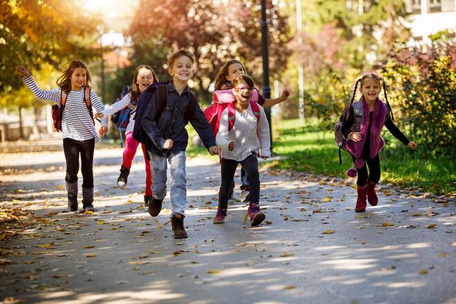 School kids running in schoolyard