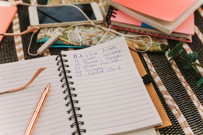 Top view of traveler's accessories and travel checklist