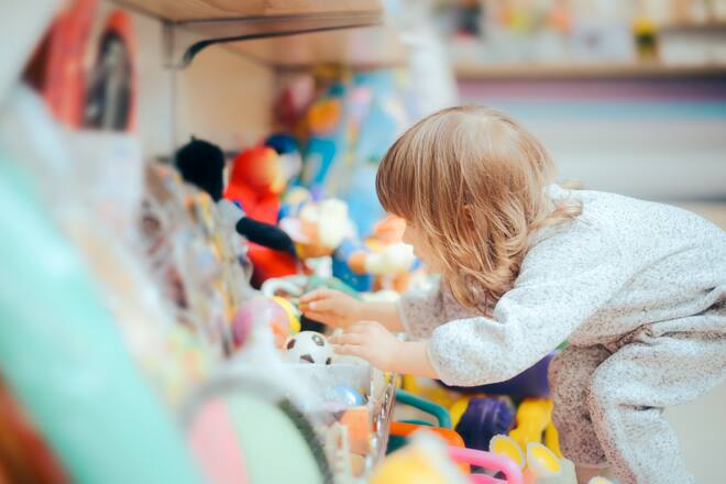 Young customer looking for a toy in kids shop expressing independence and freedom of choice