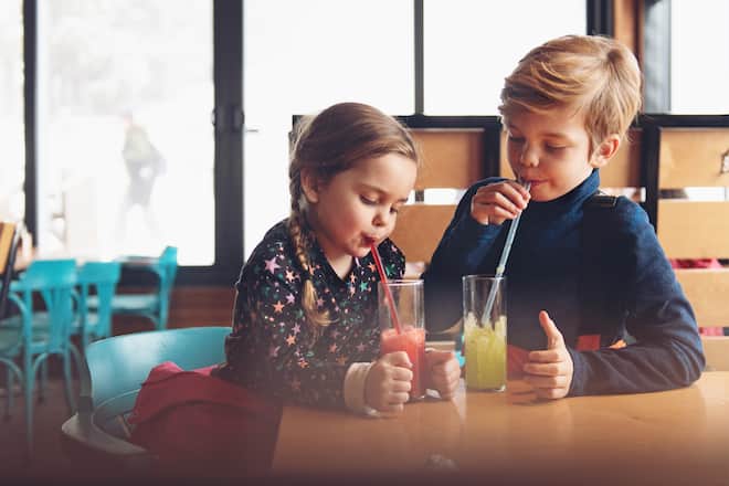 Family at a ski resort, apres ski having snack.