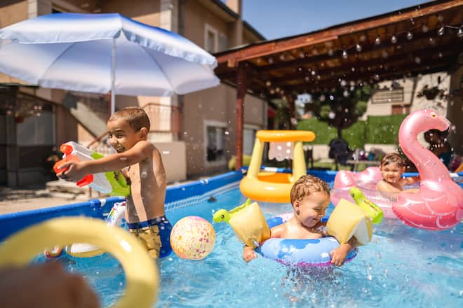 Joyful children having fun in the swimming pool.