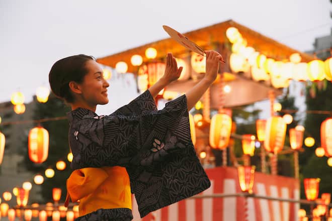 Young Japanese woman in a traditional kimono at a summer festival