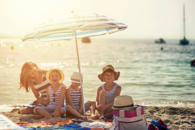 Mother wit hkids having fun on the beach. Sunny summer day. Mallorca, Spain.