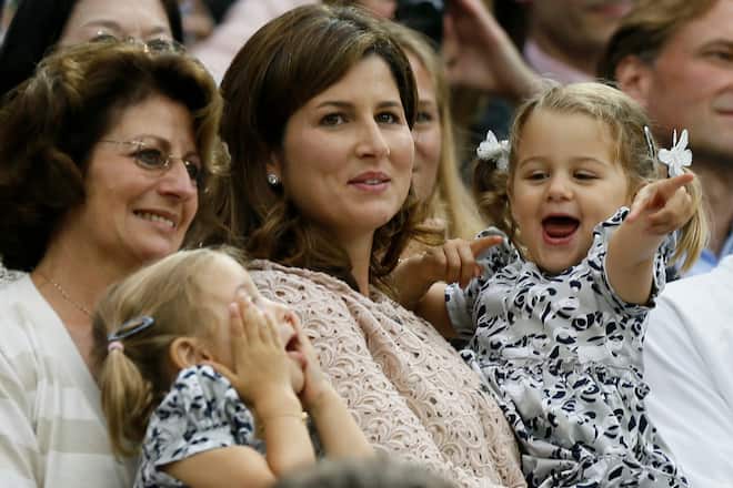 The wife of Roger Federer of Switzerland, Mirka Federer (C) with their two-year-old twins Charlene Riva and Myla Rose, celebrates after Federer defeated Andy Murray of Britain in their men's singles final tennis match at the Wimbledon Tennis Championships in London July 8, 2012. REUTERS/Stefan Wermuth (BRITAIN - Tags: ENTERTAINMENT SOCIETY SPORT TENNIS) - RTR34QQW
