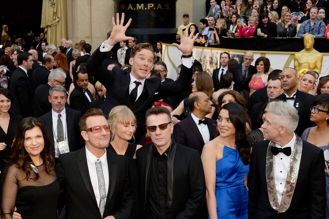 LOS ANGELES, CA - March 02: Actor Benedict Cumberbatch photo bombs the group photo of (L-R) musicians Bono, Larry Mullen, Jr. and Adam Clayton of U2 as they arrive for the Oscars held at Hollywood & Highland Center on March 2, 2014 in Hollywood, California. (Photo by Kevork Djansezian/Getty Images)