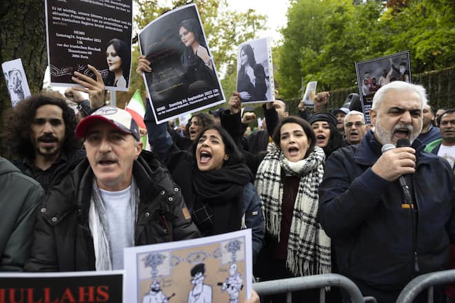 Protesters demonstrate during the global protest against the Iranian regime in front of the Iranian embassy in Bern, Switzerland, Saturday, October 1, 2022. They protest against the death of Mahsa Amini, a woman who died while in police custody in Iran. Mahsa Amini was arrested by Iran's morality police for allegedly violating its strictly-enforced dress code. (KEYSTONE/Peter Klaunzer)