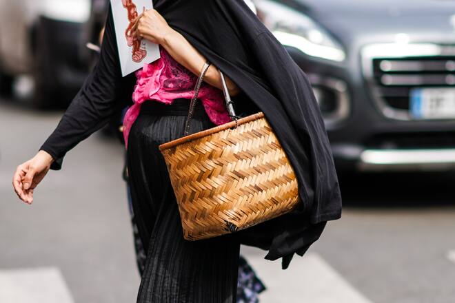 PARIS, FRANCE - JUNE 23: A guest wears a hot-pink lace top, a black pleated skirt, a bamboo woven basket , outside Paul Smith, during Paris Fashion Week - Menswear Spring/Summer 2020, on June 23, 2019 in Paris, France. (Photo by Edward Berthelot/Getty Images)