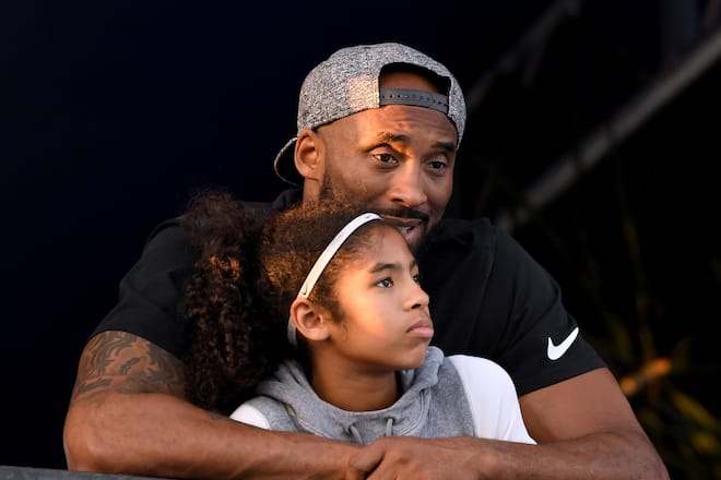 IRVINE, CA - JULY 26: Kobe Bryant and daughter Gianna Bryant watch during day 2 of the Phillips 66 National Swimming Championships at the Woollett Aquatics Center on July 26, 2018 in Irvine, California. (Photo by Harry How/Getty Images)