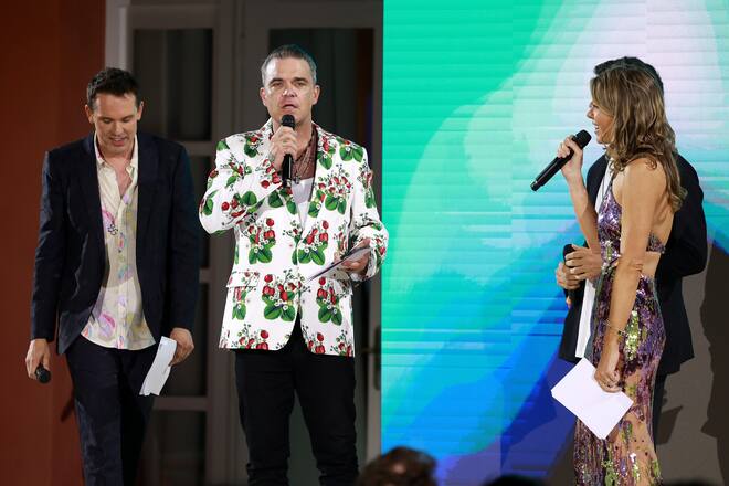 SAINT-TROPEZ, FRANCE - JULY 23: (L to R) Christian Angermayer, Robbie Williams and Louise Tabbiner speak on stage during the AURORA INSTITUTE Special Evening hosted by Christian Angermayer, Louise Tabbiner, Henry and Souraya Chalhoub at Le Beauvallon on July 23, 2022 in Saint-Tropez, France. (Photo by Arnold Jerocki/Getty Images for Aurora Institute)