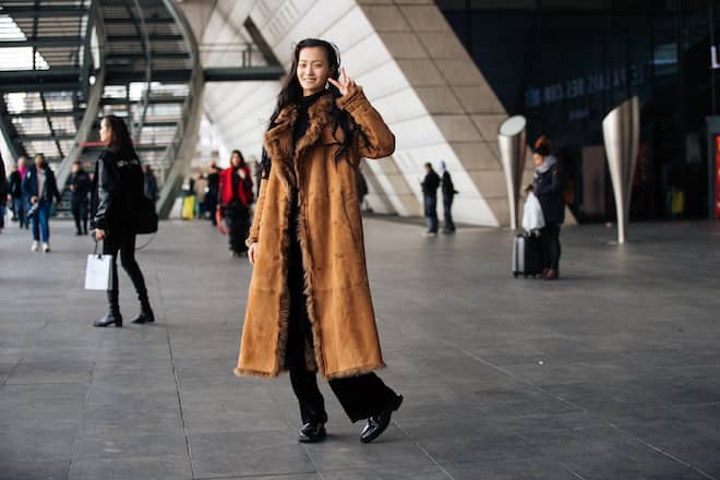 PARIS, FRANCE - MARCH 04: Model Wangy Wang Xin Yu trrows a peace sign and wears a long brown shearling coat after the Giambattista Valli show during Paris Fashion Week Fall/Winter 2019 on March 04, 2019 in Paris, France. (Photo by Melodie Jeng/Getty Images)