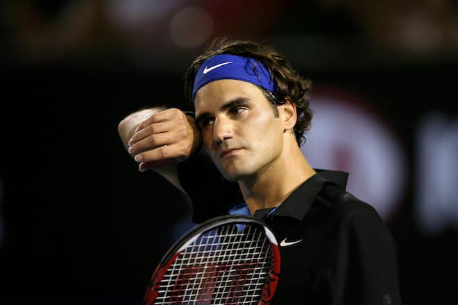 MELBOURNE, AUSTRALIA - JANUARY 25: Roger Federer of Switzerland wipes his forehead during his semi-final match against Novak Djokovic of Serbia on day twelve of the Australian Open 2008 at Melbourne Park on January 25, 2008 in Melbourne, Australia. (Photo by Clive Brunskill/Getty Images)