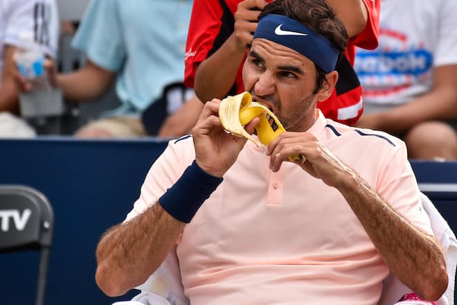 MONTREAL, QC - AUGUST 10: Roger Federer of Switzerland eats a banana as he rests in between games against David Ferrer of Spain during day seven of the Rogers Cup presented by National Bank at Uniprix Stadium on August 10, 2017 in Montreal, Quebec, Canada. (Photo by Minas Panagiotakis/Getty Images)