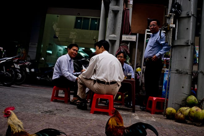 Office workers eat breakfast on the streets in downtown Ho Chi Minh City, Vietnam, on Tuesday, Dec. 27, 2011. Vietnam's gross domestic product growth is estimated at 5.9 percent this year, according to a statement on the government's website last week. Photographer: Justin Mott/Bloomberg via Getty Images