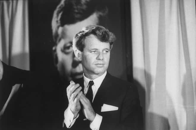 Robert. F. Kennedy campaigning in front of large poster portrait of his brother President John F. Kennedy. (Photo by Bill Eppridge/The LIFE Picture Collection via Getty Images)